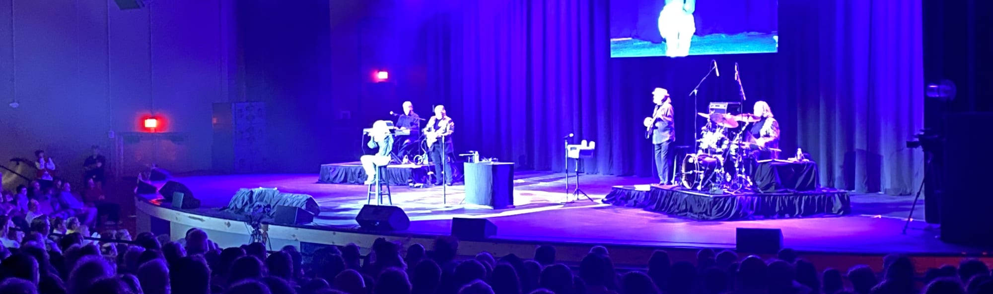 signer on stage in chair washed out by the lights Youngstown